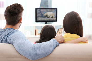 Wall Mural - Family watching TV on couch