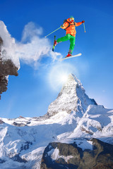 Skier jumping against Matterhorn peak in Switzerland.