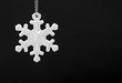 Black and white photo of safety reflector in the form of snowflakes. Necessary equipment to pedestrians for walks during dark conditions.