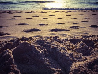 Sand and the sea with the sunrise in vintage style