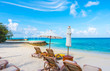 Beach chairs with umbrella at Maldives island with white sandy b