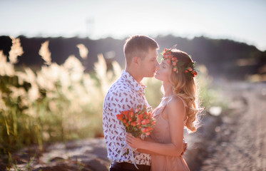 charming and young man and woman standing together on sandy path