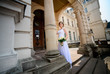 © IVASHstudio - young and beautiful bride in white dress standing near manor