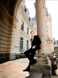 © IVASHstudio - young and handsome groom in black suit standing near manor