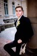© IVASHstudio - young and handsome groom in black suit standing near manor