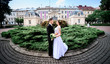 © IVASHstudio - young and beautiful bride and groom standing near manor