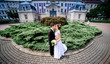 © IVASHstudio - young and beautiful bride and groom standing near manor