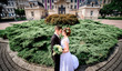 © IVASHstudio - young and beautiful bride and groom standing near manor