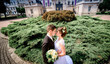 © IVASHstudio - young and beautiful bride and groom standing near manor
