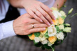 © IVASHstudio - hands of the bride and groom on wedding bouquet