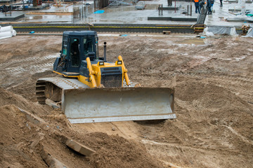 bulldozer conducting excavation works in the pit on a large cons