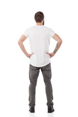 Back pose, full length shot of a young man looks ahead isolated