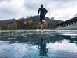 © Giorgio Pulcini - Man running on athletic track in a rainy day