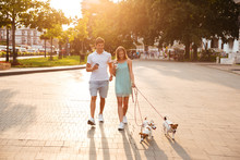 Couple With Their Dogs Walking Outside