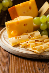 Mix cheese on wooden board.