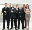 © ASDF - Mature businessman and cheerful business team on office backgrou