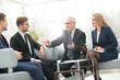 © ASDF - Mature businessman discussing  with his partner and colleagues i