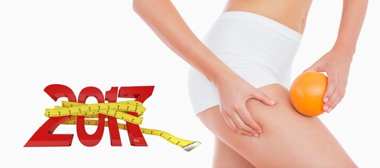 Poster - Composite image of woman squeezing fat on thigh as she holds ora