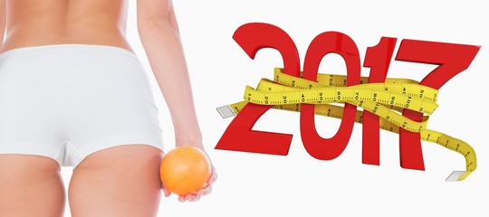 Poster - Composite image of midsection of fit woman with orange