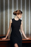 Gorgeous lady in elegant evening black dress with deep cut in st Stock  Photo