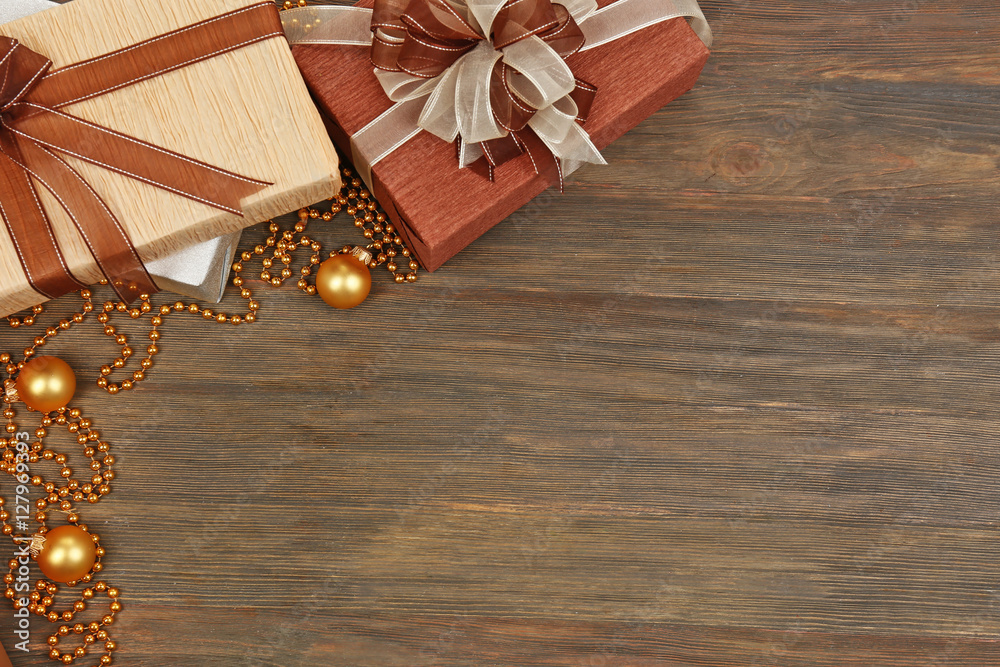 Christmas presents with decor on wooden background