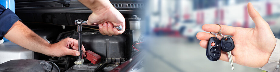 Hands of car mechanic with wrench in garage.