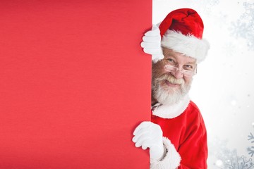 Poster - Composite image of santa claus peeking from red board