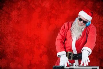 Wall Mural - Composite image of dj santa claus mixing sound