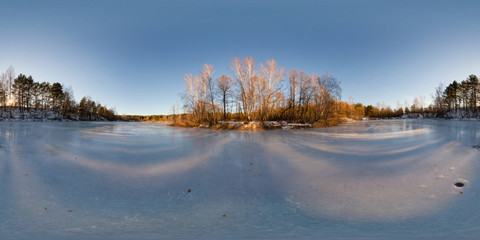 Equidistant 360 degrees panorama of a frozen lake in winter forest