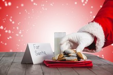 Composite Image Of Close-up Of Santa Claus Taking Cookies