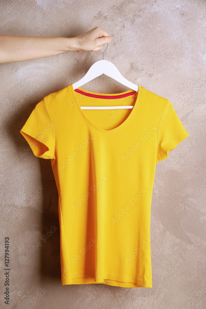 Blank yellow t-shirt on grunge background
