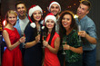 © Africa Studio - Young people with glasses of champagne at Christmas party