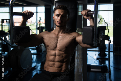 Man Doing Butterfly Chest Exercise On Machine Buy This