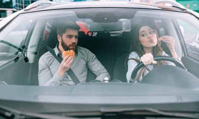 Front view of funny couple in car