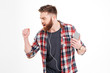 © Drobot Dean - Casual bearded man listening music in earphones and dancing