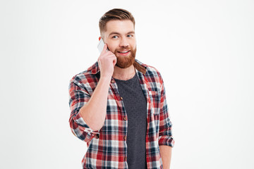 Wall Mural - Portrait of a casual bearded man talking on the phone
