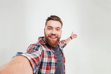 Close Up Portrait Of A Cheerful Bearded Man Taking Selfie