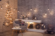 Creative wooden Christmas tree at the brick wall of Loft style room with burning bulbs garland and modern fireplace. Scandinavian winter interior of room. Horizontal