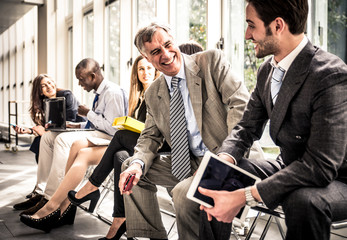 Row of business people waiting for an interview