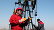 Petroleum Engineers Teamwork / Petroleum engineers at work in the oil and gas industry