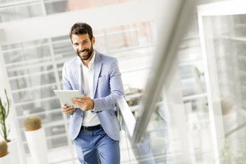 Wall Mural - Young businessman with tablet