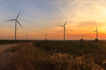 Wind turbine power generator farm at sunset