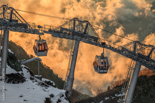 Cableway Lift Gondola Cabins On Cloudy Mountain Sunset Background