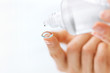 © puhhha - Woman Hand With Contact Eye Lens And Cleansing Solution