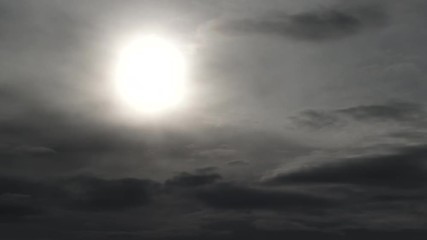 Wall Mural - dark and eerie clouds fill the sky with sun becoming more and more dim, time lapse.