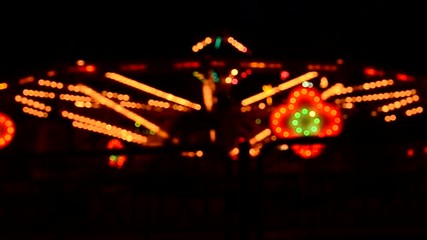 Wall Mural - Blurred Amusement park ride at night.
