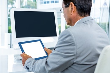 Poster - Businessman looking at his tablet 