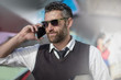 © Westend61 - Smiling man wearing sunglasses talking on cell phone