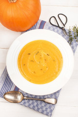 Wall Mural - healthy pumpkin soup with thyme in a deep plate