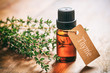 © Rawf8 - Thyme oil on wooden background, tag with text